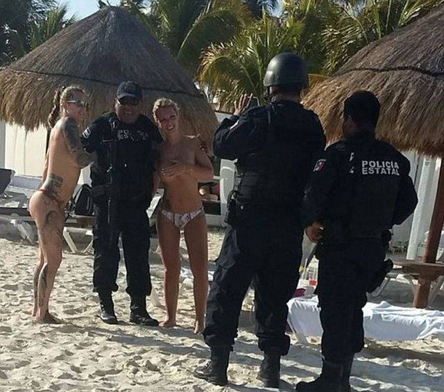 Cancun Cops Got Punished For… Posing With Topless Girls