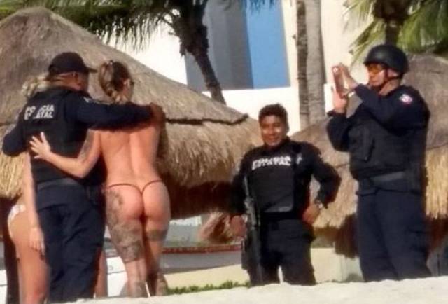Cancun Cops Got Punished For… Posing With Topless Girls